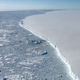 The western edge of iceberg A68 and the new edge of Larsen C Ice Shelf in the distance. Photo: NASA/Nathan Kurtz